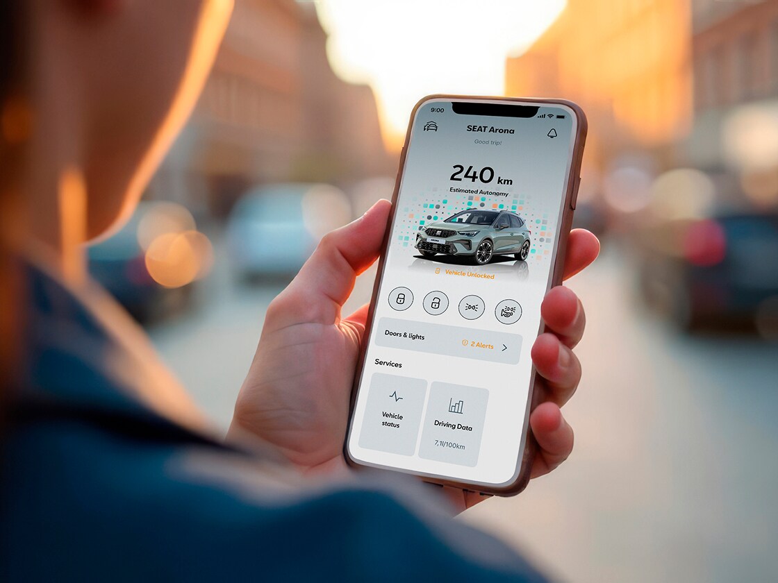 Person holding their smartphone using my SEAT app