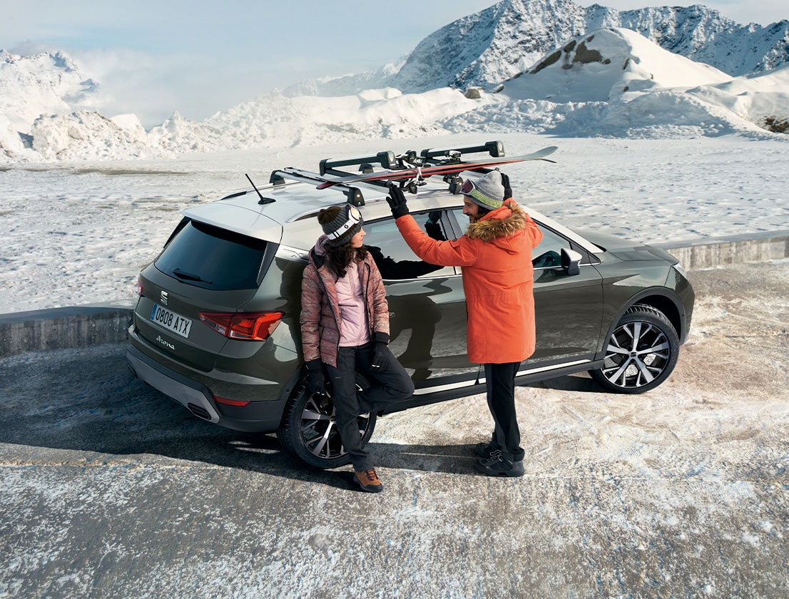 man woman using ski rack attached to their seat