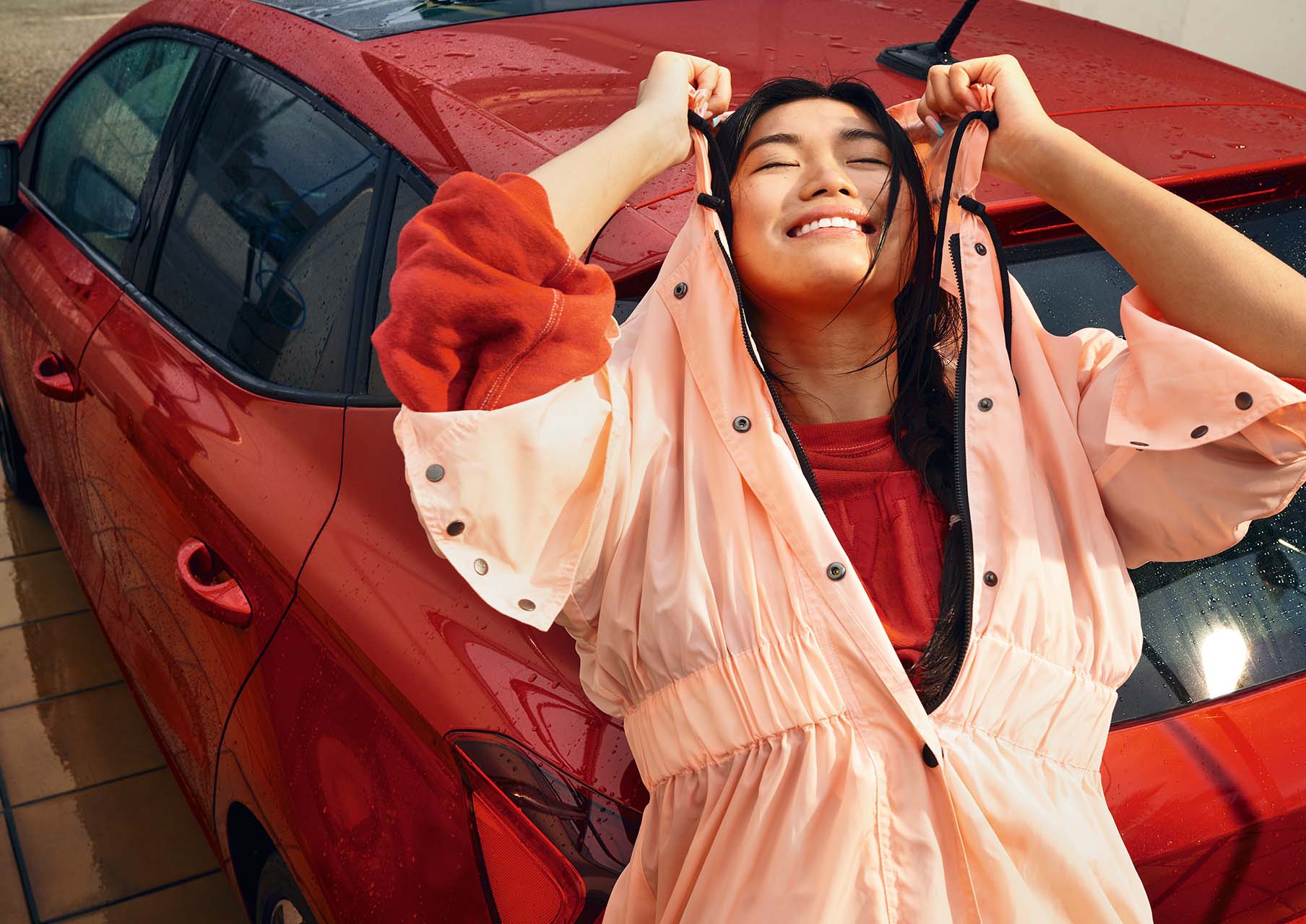 woman smiling leaning on the seat ibiza desire red