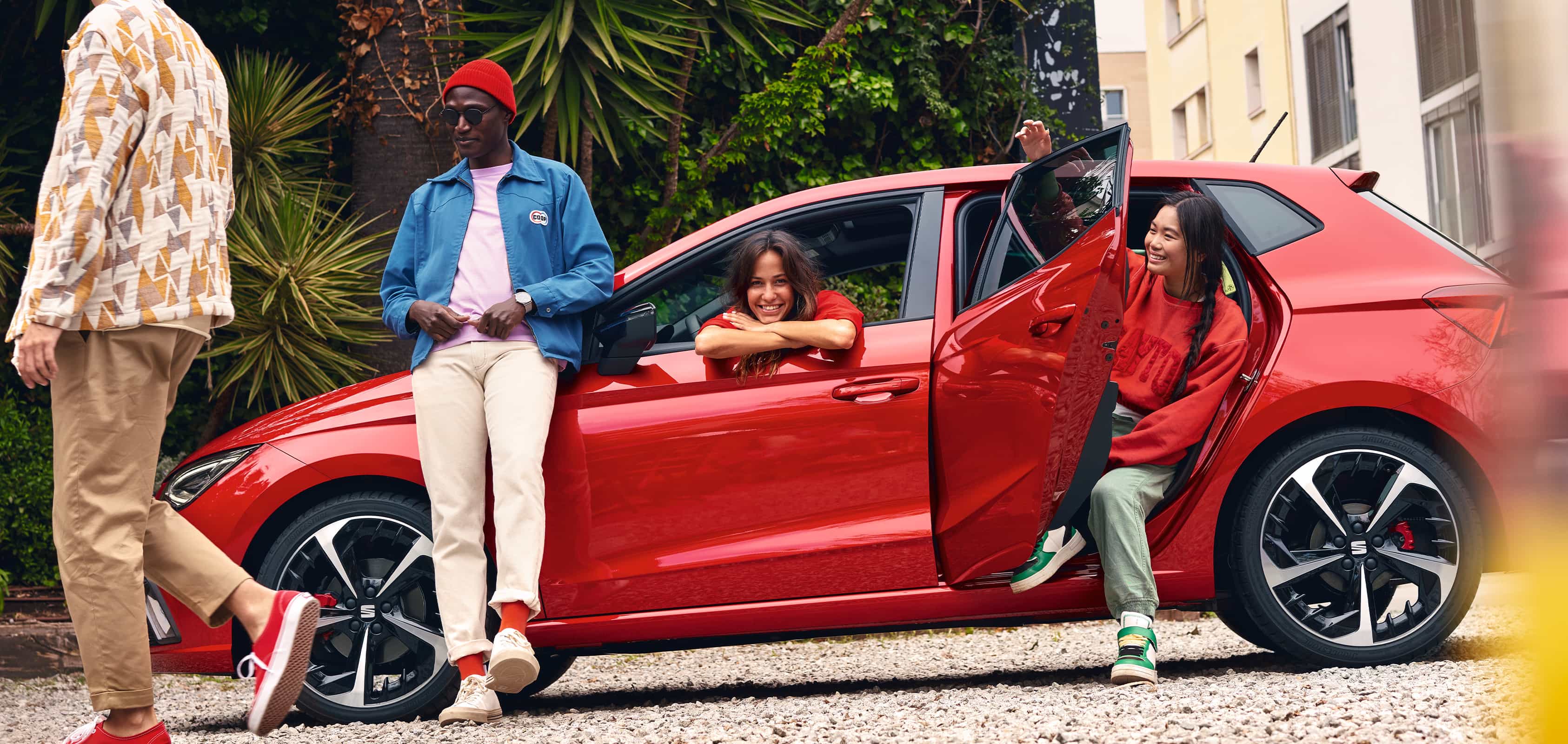 Friends hanging out in the SEAT Ibiza desire red colour