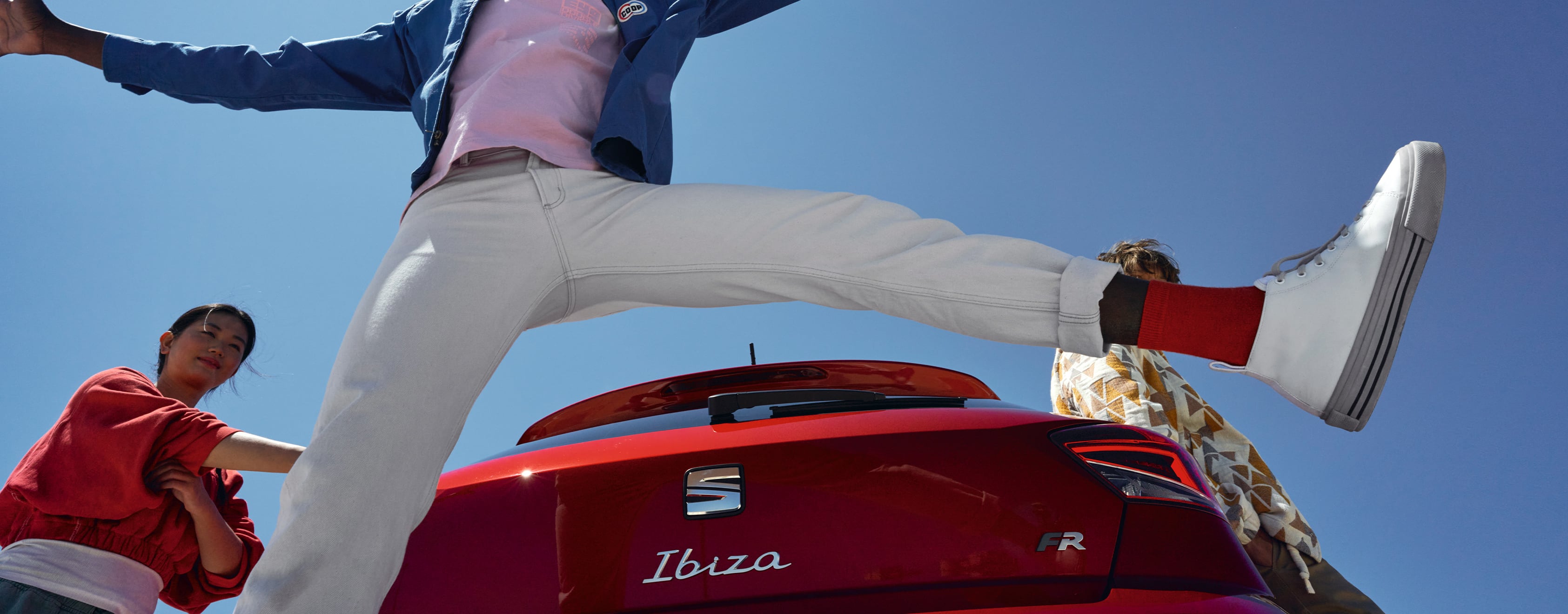 Man, jumping behind SEAT Ibiza desire red colour FR trim