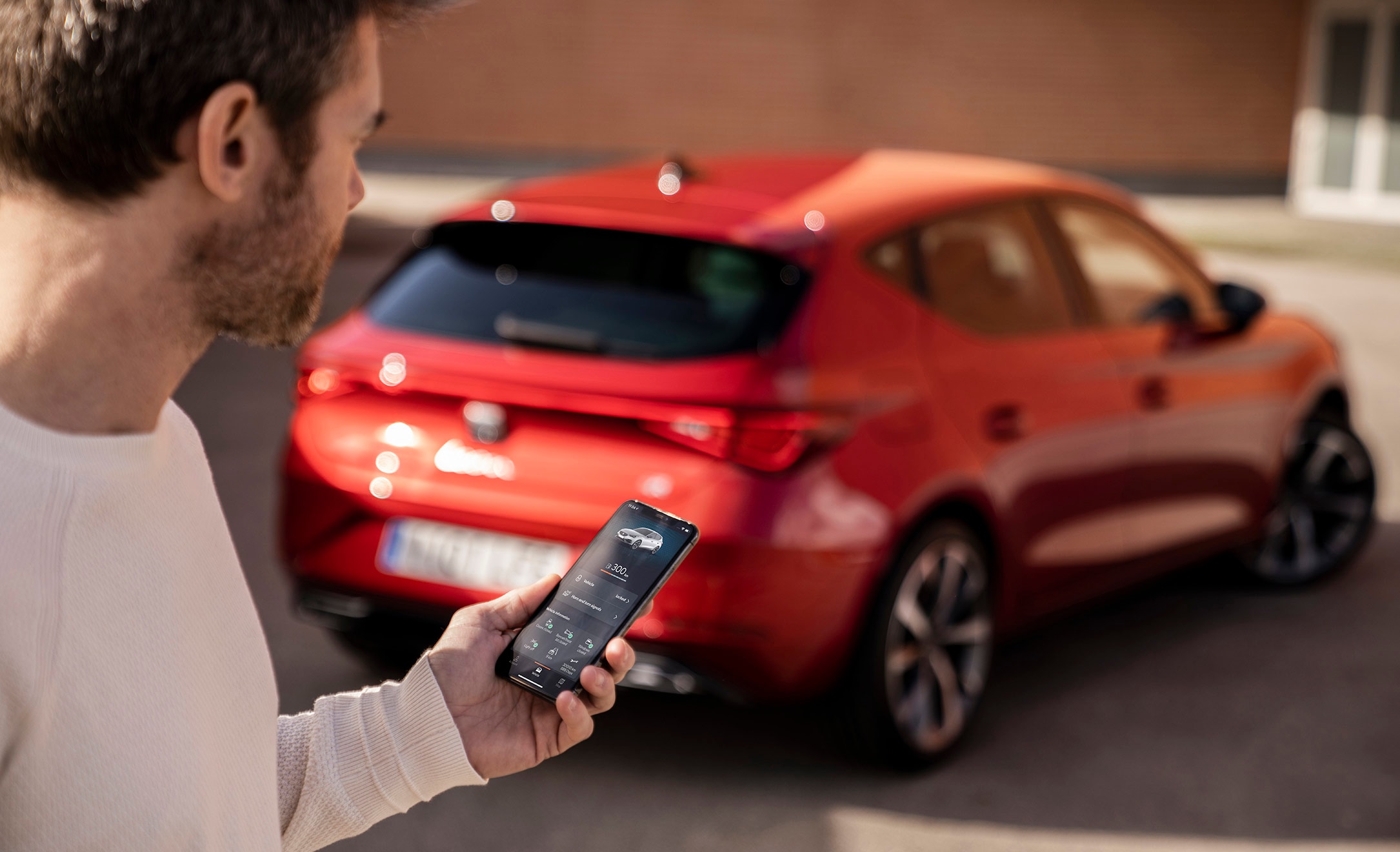 New SEAT Leon Sportstourer person holding phone with app