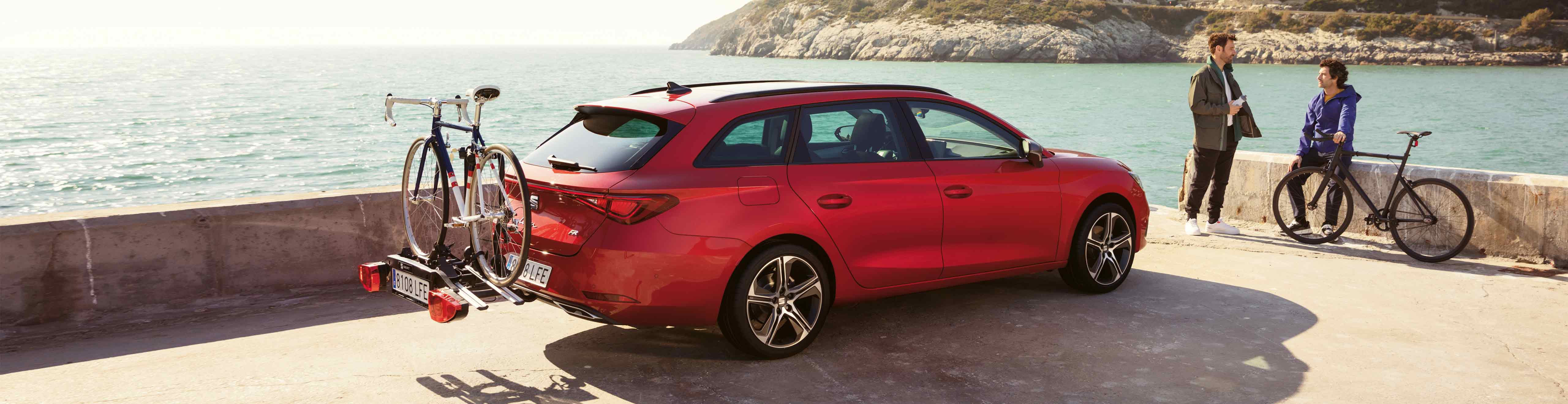 SEAT Leon Sportstourer desired red colour with a bike rack